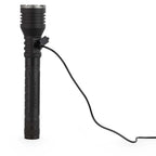 Black LED flashlight with a charging cable plugged in on a white background