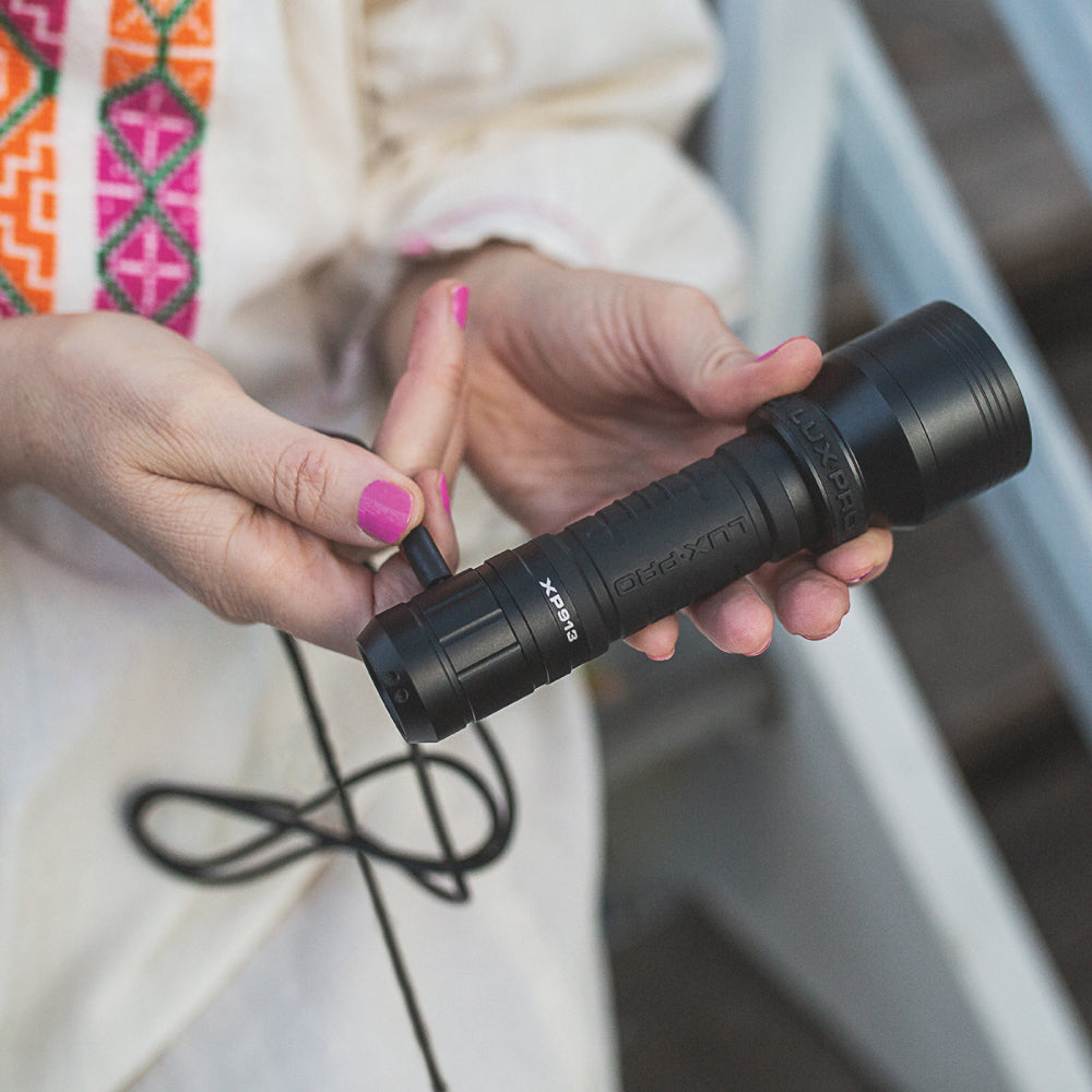 Image of lady plugging in Rechargeable Flashlight 