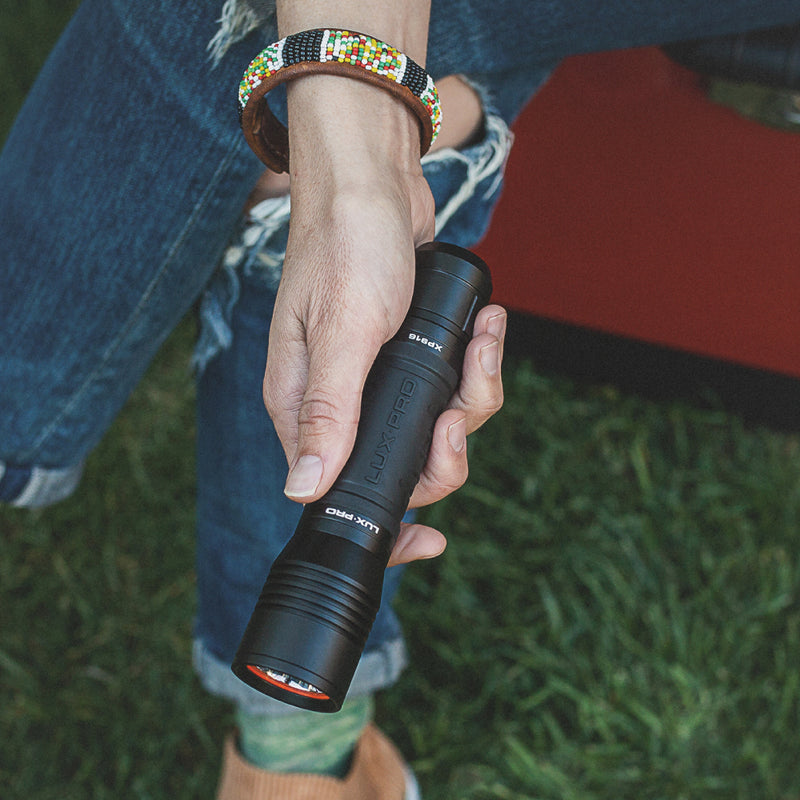 LED Rechargeable Flashlight in persons hand