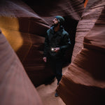 Guy with tactical flashlight in red rock canyon