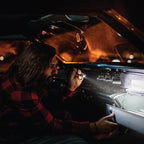 Man looking into glove box with LED Pen Light