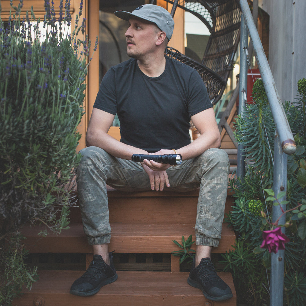 LED Rechargeable Flashlight side view in guys hand