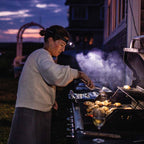 Camping headlamp being worn while cooking on a grill 