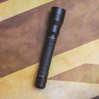 LED Flashlight with yellow and brown background
