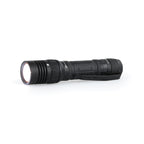 Horizontal LED tactical flashlight with flashlight turned on 