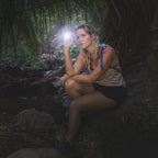 Image of a lady holding LED flashlight in the outdoors